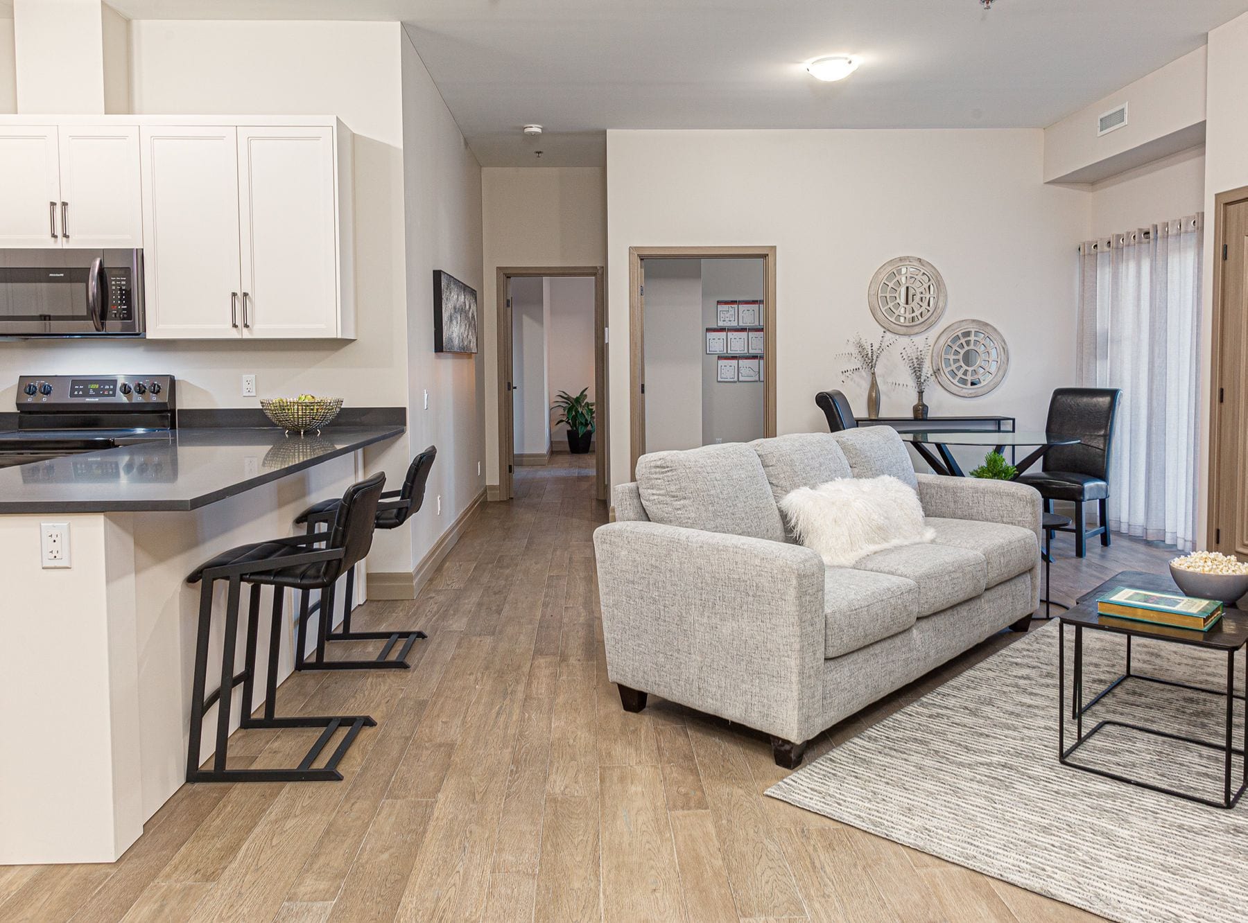 Open-concept suite living room and kitchen